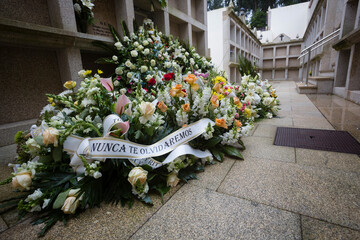 Tombs and bouquets of flowers in the niches of a cemetery in Galicia, Spain