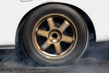 Car wheel spinning wheel and smoking, Race car doing lot of smoke on race track, Car wheel drifting and smoking on track. - Powered by Adobe