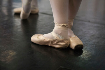 Feet of a ballerina with slippers during a rehearsal