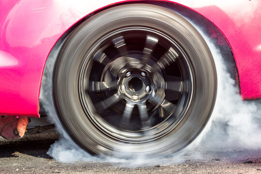 Car Wheel Spinning Wheel And Smoking, Race Car Doing Lot Of Smoke On Race Track, Car Wheel Drifting And Smoking On Track.