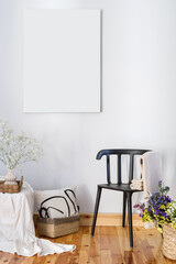 hygge style at home interior, chair, flowers and blank picture on wall
