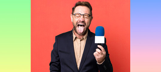 middle age man with cheerful and rebellious attitude, joking and sticking tongue out. journalist...