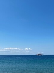 Fototapeta na wymiar Vertical shot of a ship in the sea