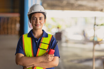 Portrait Indian woman worker supervisor smart confident look with engineer safety suit work in large factory warehouse industry - Powered by Adobe