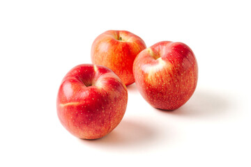 Ripe juicy red apples with leaves on white background