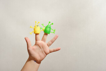 two fingers wearing puppets aliens. Kid playing fingers puppets. Finger theater for children