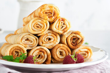 Pancakes. Stack of crepes or thin pancakes with berries, with raspberries and honey for breakfast. Pancake day is traditional american or english holiday concept. Homemade breakfast. Selective focus.