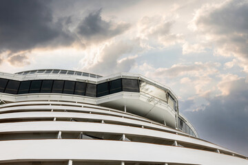 Cruise ship navigational bridge deck on modern boat with beautiful sky behind.