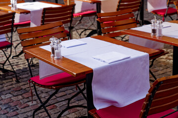 Terrace with laid tables of restaurant at the old town of Zürich on a sunny autumn day. Photo taken October 30th, 2022, Zurich, Switzerland.