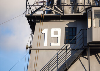 Number 19 in large white font on grey metal NATO war ship in English Channel
