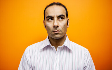 Obraz premium Emotions and Expressions: Uncertain. A concerned look and expression on the face of a mixed race mature man. From a series of related images.