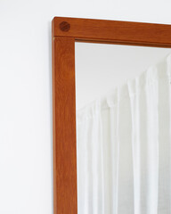 Vintage danish modern wooden teak frame mirror. Angle view corner detail.