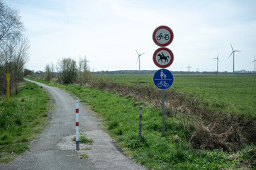 Permission signs for horse riding, walking, cycling and riding a scooter on the road. 