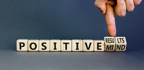 Positive results and mind symbol. Concept words Positive results or Positive mind on wooden cubes. Businessman hand. Beautiful grey background. Business positive results and mind concept. Copy space