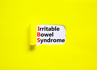 IBS irritable bowel syndrome symbol. Concept words IBS irritable bowel syndrome on white paper on a beautiful yellow background. Medical and IBS irritable bowel syndrome concept. Copy space.