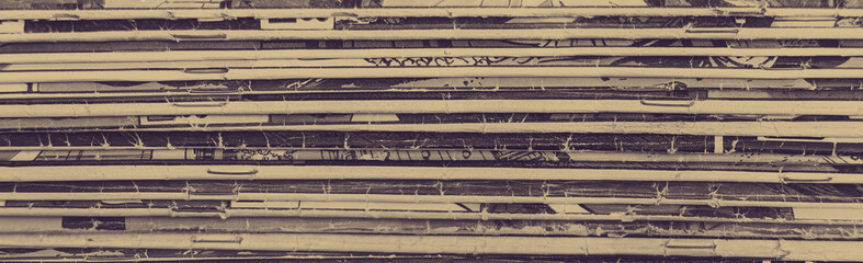 Collection of old vintage comic books stacked in a pile creates background texture of old faded...