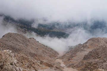 Fog on top of mountain Tahtali in Kemer, Turkey. Foggy view from the mountain. Natural background