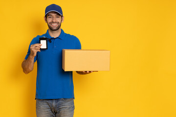 Happy delivery man with a smile arriving with a package for you showing his name tag isolated on...