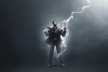 Fototapeta premium Strong business man on dark background