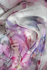 Transparent silk fabric background.  Texture of satin wave shape design.  Colorful silky textile material with elegant abstract clothing detail.