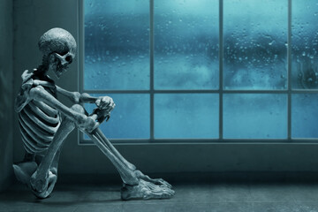 Human skeleton death sitting alone at home