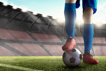 Football player man in a blue jersey standing with the ball
