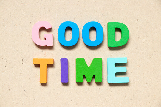 Color alphabet letter in word good time on wood background