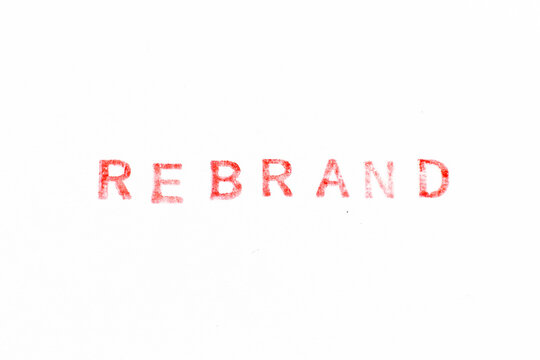 Red color ink rubber stamp in word rebrand on white paper background