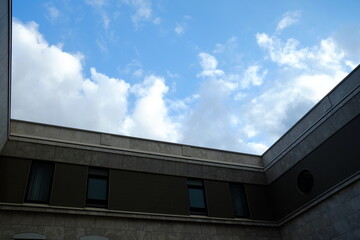 Scenery of White Cloud and Blue Sky from Window of Vintage Building.