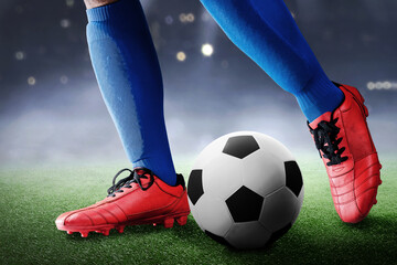 Football player man in a blue jersey kicking the ball
