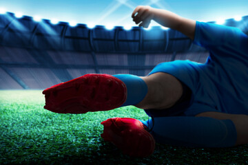 Football player man in a blue jersey with tackling the ball