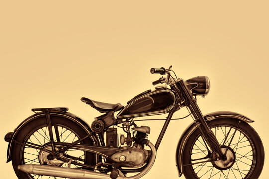 Sepia toned side view image of a vintage motorcycle