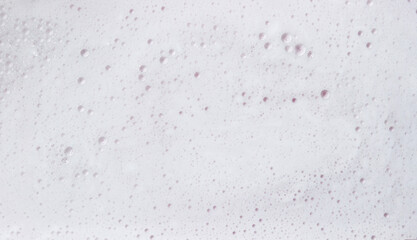 Soapy water texture. Foam on the surface of the water as a background for the image. The concept of cleanliness and wash.