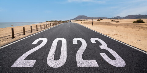 2023 New Year road trip travel and future vision concept . Nature landscape with highway road leading forward to happy new year celebration in the beginning of 2023 for fresh and successful start