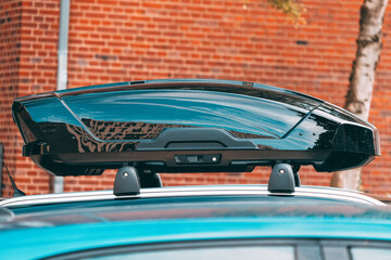 plastic roomy trunk on the roof of the car. The concept of traveling to nature