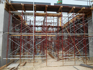Naklejka premium JOHOR, MALAYSIA -APRIL 13, 2016: Scaffolding used as the temporary structure to support platform, form work and structure at the construction site. Also used it as a walking platform for workers. 