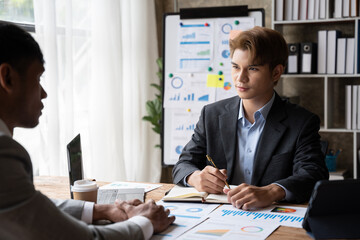 Sharing opinions. Group of young modern people in smart casual wear discussing business while working in the creative office