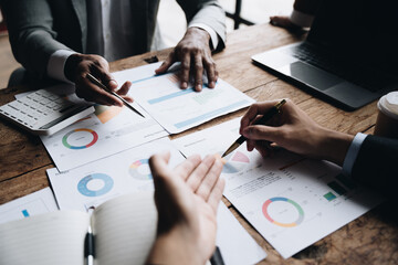 Group of business people meeting at office for analyzing data by using tablet and laptop and discussing for planning strategy and brainstorming for new project