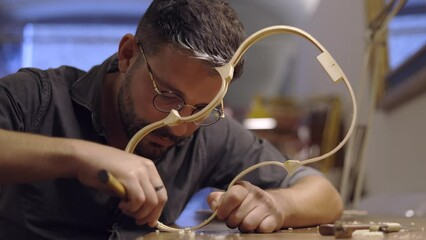 Luthier creating violin ribs in workshop