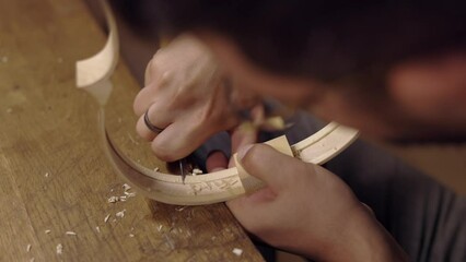 Anonymous luthier creating violin ribs in workshop