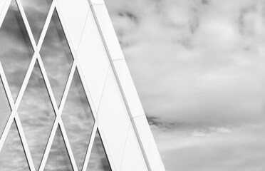 Reflection of cloud and sky on glass window of modern architecture. Building abstract background