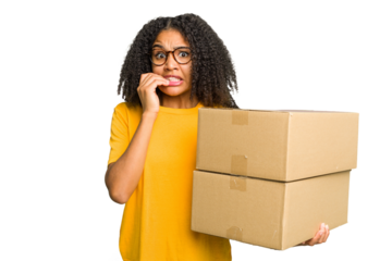 Young african american woman moving to other house while picking up a box full of things isolated biting fingernails, nervous and very anxious.