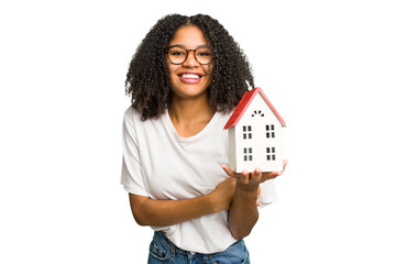 Young african american woman moving to a new home while picking up a box full of things isolated laughing and having fun.