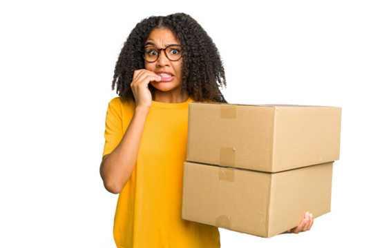 Young african american woman moving to other house while picking up a box full of things isolated biting fingernails, nervous and very anxious.