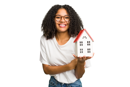 Young african american woman moving to a new home while picking up a box full of things isolated laughing and having fun.