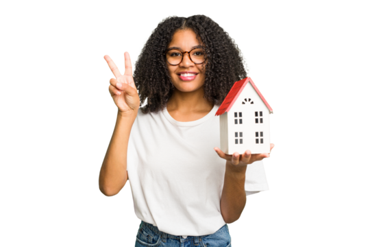 Young african american woman moving to a new home while picking up a box full of things isolated showing number two with fingers.