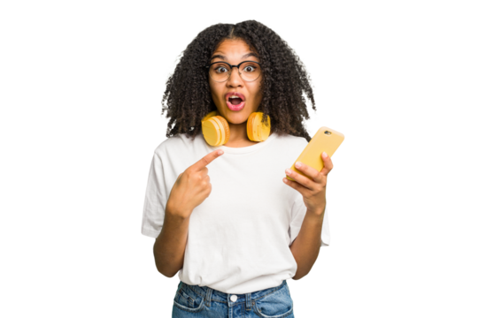 Young african american woman listening to music with yellow headphones isolated pointing to the side