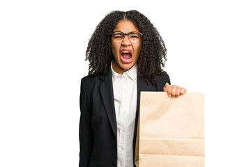 Young african american business woman holding a take away bag isolated screaming very angry and aggressive.