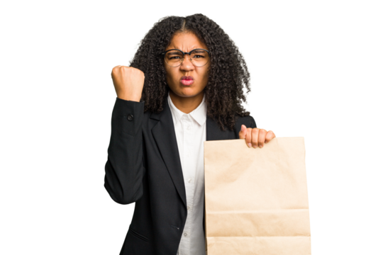 Young african american business woman holding a take away bag isolated showing fist to camera, aggressive facial expression. - Powered by Adobe