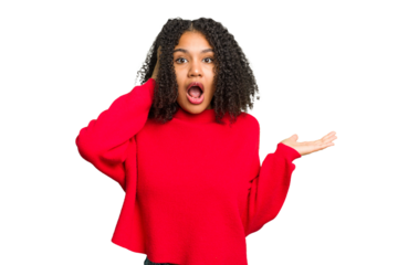 Young african american woman isolated impressed holding copy space on palm.